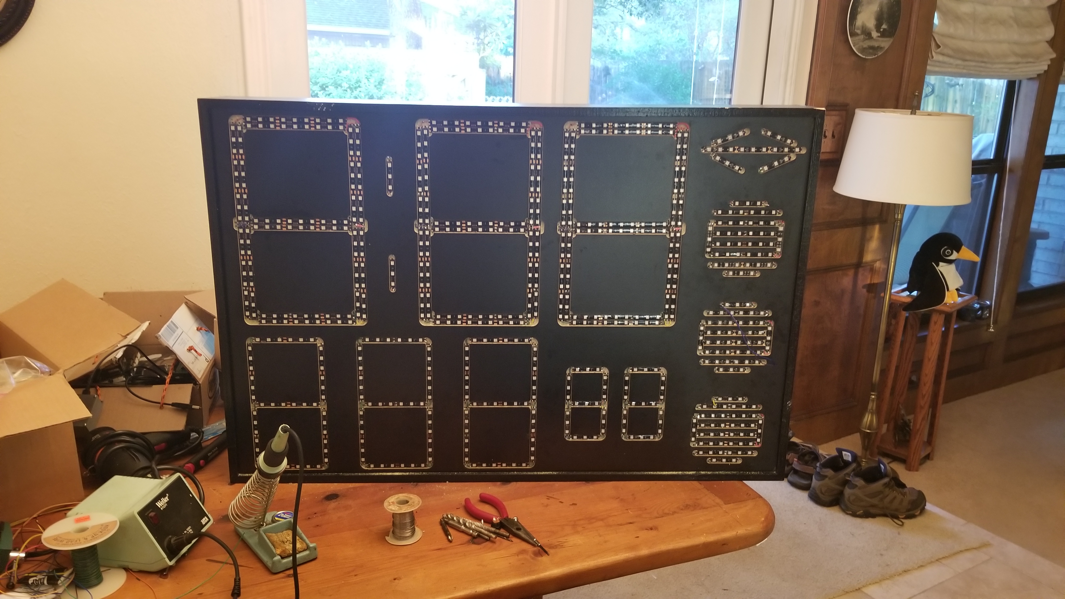 Large LED segment scoreboard panel under construction on a workbench