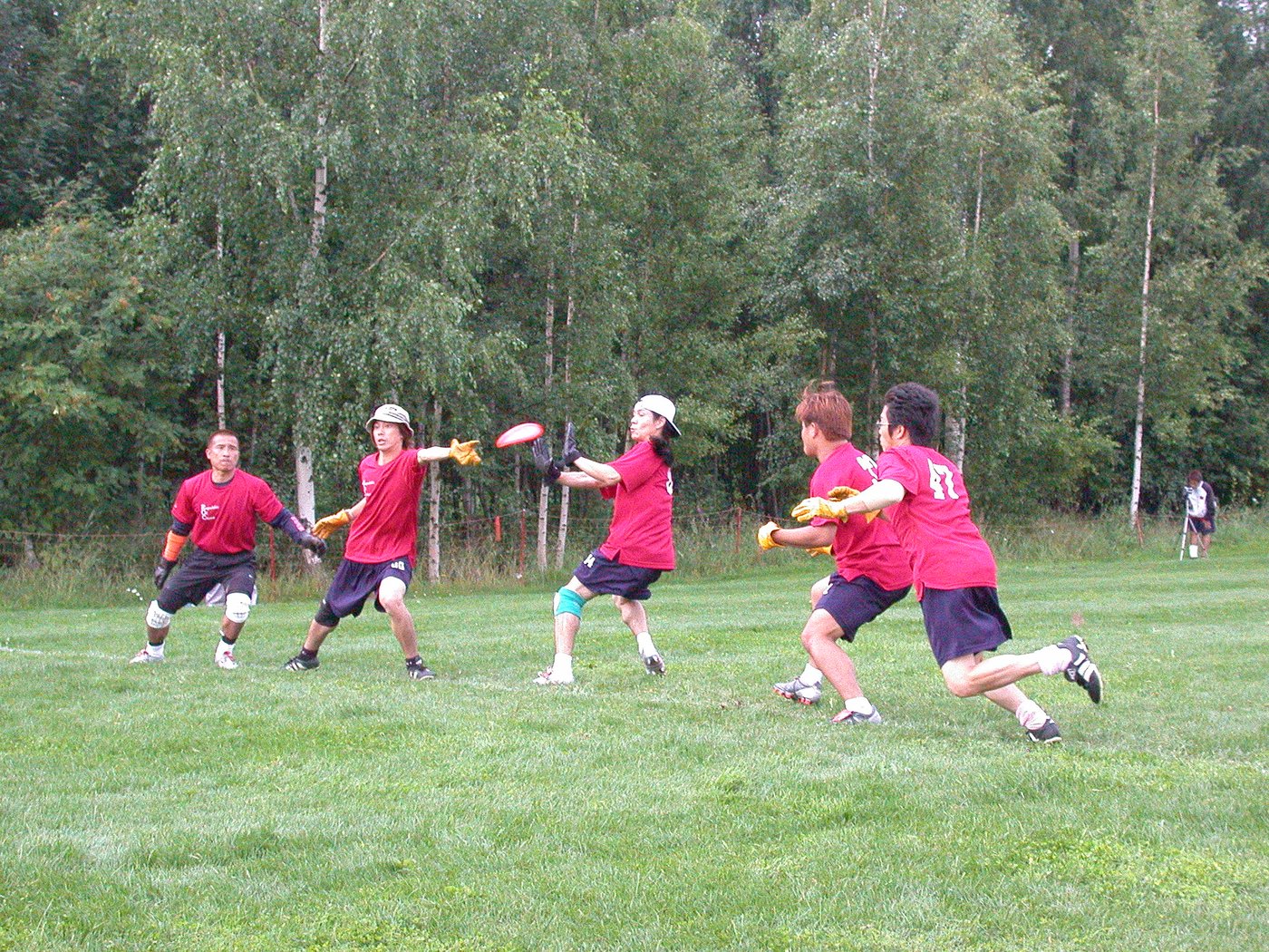 Team in red jerseys defending during guts at the WFDF World Championships