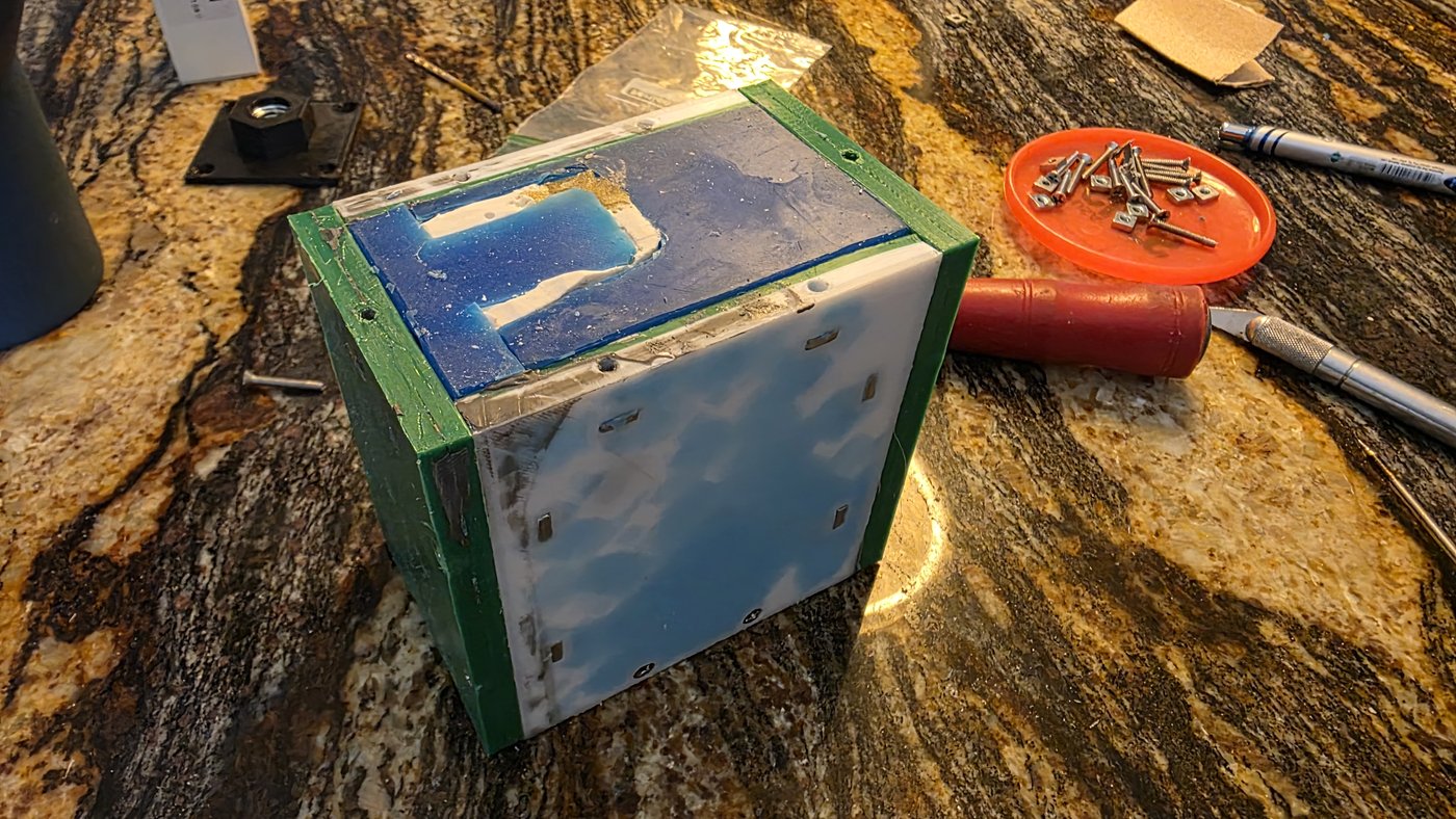 Custom bow grip mold assembled in a green casting frame with platinum silicone